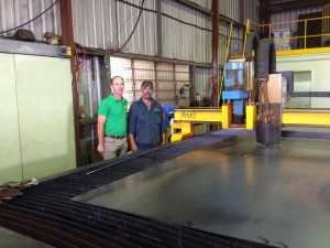 General Manager Troy Law (left) and operator Graham Hunt in front of the ART HDP plasma cutter in their Dalby-based factory.